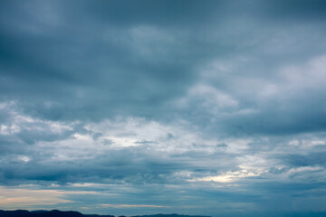 Fototapeta na wymiar Stormy heavy sky with dark rainy gloomy dramatic clouds with nobody on the horizon 