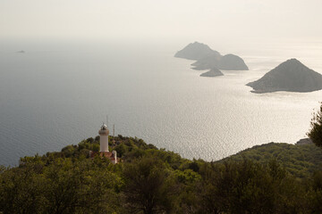 view from the top of the mountain on the lighhouse and the islands in the ocean