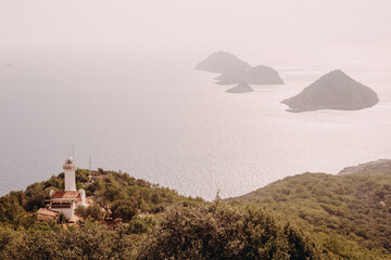 view from the top of the mountain on the lighhouse and the islands in the sea