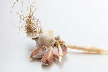 Garlic pestle with stem on white background.