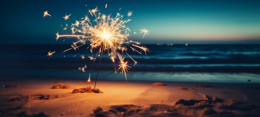 Sylvester New Year, Vacation holiday New Year's Eve 2024 party event celebration holiday greeting card - Closeup of sparkling sparkler stuck in sand on beach with ocean in teh background - obrazy, fototapety, plakaty