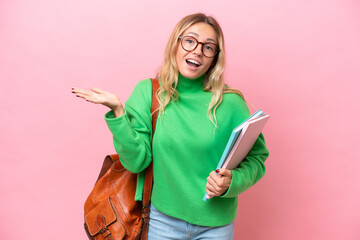 Young student woman isolated on pink background with shocked facial expression