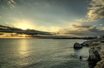 Fototapeta na wymiar Splendid summer sunset with cloudy sky at rocky Cypriot coast