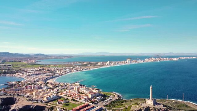 Aerial drone perspective of famous region La Manga, Murcia Province. Spain. View of "Cabo de Palos" - Cape Palos. Drone backward creating a beautiful panorama of all region. Famous Travel Destination