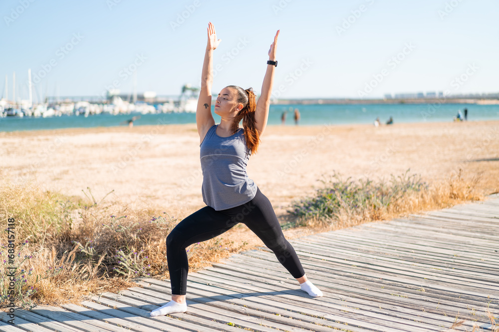 Sticker Young pretty sport woman doing yoga