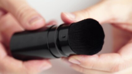 Demonstration of makeup brush texture. One make up black brush for face powder, close up, macro texture.