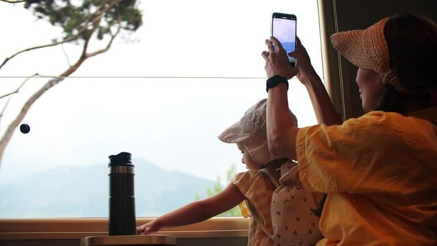 Mom and her little daughter travel together by train in France