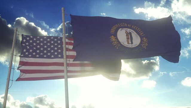 The Kentucky state flags waving along with the national flag of the United States of America. In the background there is a clear sky