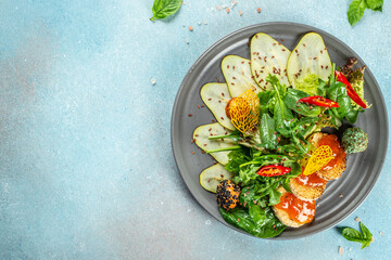 pear salad, greens and cheese on a light background top view. place for text
