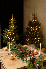 Christmas table with candles and Christmas tree and decorations