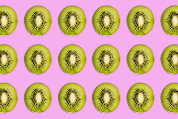 Kiwi pattern on bright pink  background. Minimal flat lay food texture. Summer abstract trendy...