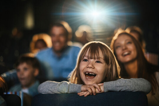 Girl watching a film in movie theater
