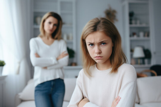 Upset girl hold hands crossed in front and woman behind avoid to talk after quarrel at home, offended teen daughter and young aged mum argument, family conflict concept