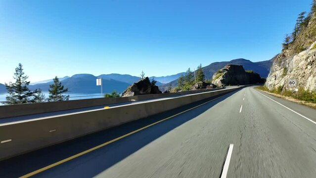 Driving on Sea to Sky Highway between Squamish and Vancouver, BC, Canada. Sunny Day, Fall Season.