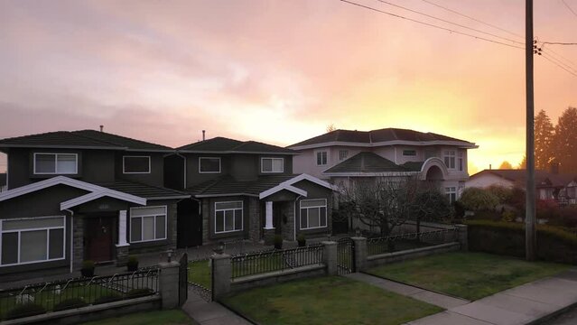 Road and Homes in Suburban Neighborhood, Sunset. Fall Season. Burnaby, British Columbia, Canada.