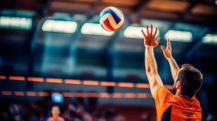Fotobehang Male volleyball player reaching for ball with hands © TopMicrobialStock