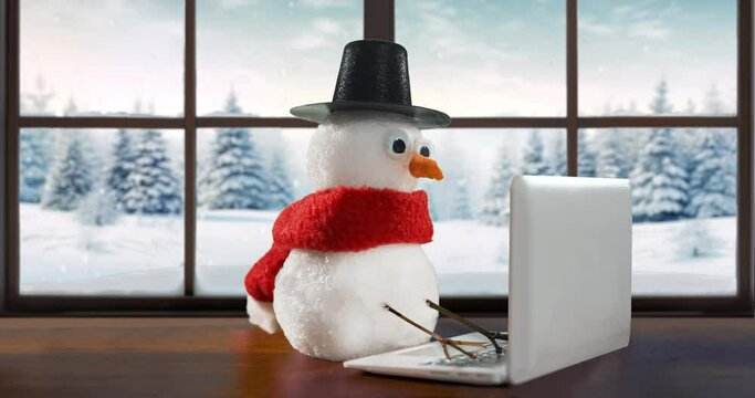 Funny snowman looking for Christmas gifts, browsing Christmas shopping online using his laptop. Cozy home, beautiful winter background outside the window. The snowman ordering gifts for Christmas