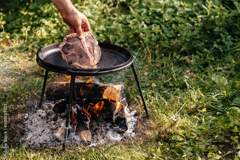 Wall mural beef steaks on the grill. banner, menu, recipe place for text, top view