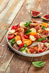 Fresh salad with figs on a wooden background. top view. copy space
