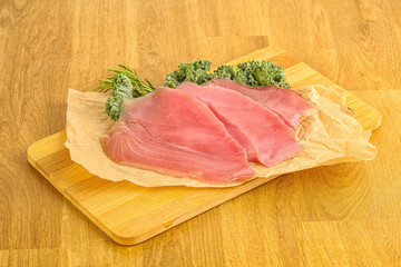 Raw salted tuna slice over board