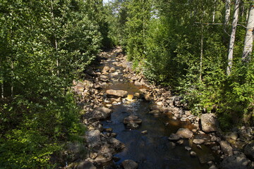 A creek flowing in the river Skellefteälven in Skelleftea, Sweden, Europe
