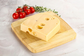 Maasdam cheese brick over board