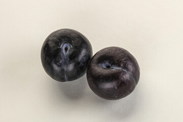 Two ripe sweet black plums