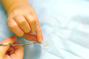 Girl's hands cutting her fingernails