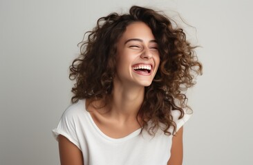 young woman laughing on white background