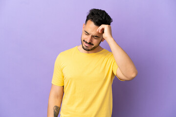 Young caucasian man isolated on purple background with tired and sick expression