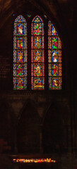 Antique stained glass window and candles light in Saint Stephen cathedral of Metz, France. 
