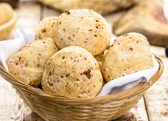 bowl full of traditional brazilian cheese bread or cheese biscuit, served crispy and hot, with coffee