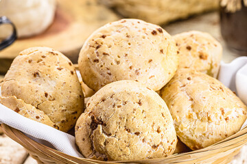 bowl full of traditional brazilian cheese bread or cheese biscuit, served crispy and hot, with coffee