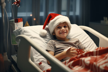 niño ingresado en habitación de hospital con gorro de papá noel, sosteniendo un regalo entre las manos