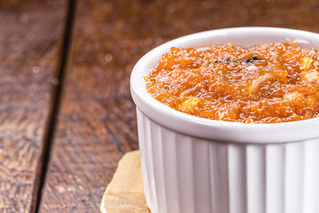 Brazilian pumpkin jam made by emc asa, in a rustic wooden setting, copyspace
