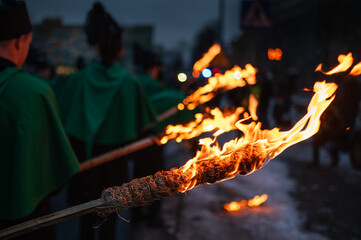 Torches held by participants of a parade or march