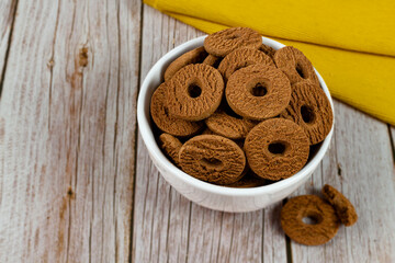 Ring chocolate biscuits served in a bowl. Brazilian little donut. Selective focus.	