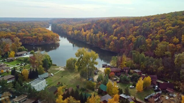 Aerial flight above river with autumn colorful trees forest near Korobovy Hutora (Koropove village). Siverskyi Donets River in Ukraine