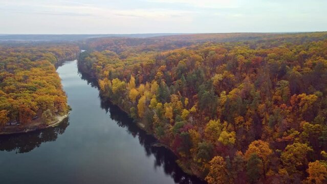 Autumn aerial drone forward flight above the river with forest riverbanks. Cossack mountain, Korobovy Hutora (Koropove village) on Siverskyi Donets River in Ukraine