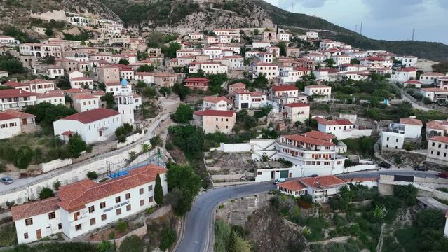 Dhermi at Sunset time. Aerial Shot of Beautiful Village Sea View, Stone Houses, beach Resort in Mountains of Albania