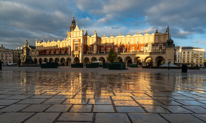 Renaissance Cloth Hall on Krakow Main Square reflecting in the wet cobblestones, sunny morning, Cracow, Poland - 688192934