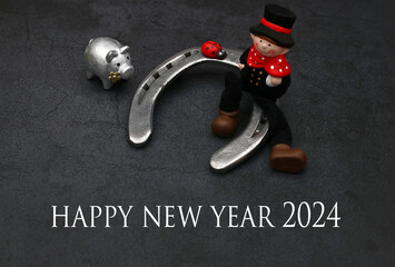 Horseshoe, chimney sweep and lucky pig with the text Happy New Year 2024.