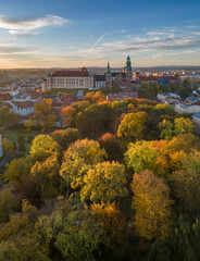 Wawel castle and cathedral over colorful autumn park in the morning sun, Krakow, Poland