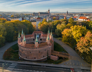 Barbicane (Barbakan), part of medieval gothic city fortification in the sunny autumn morning, aerial view, Krakow, Poland - obrazy, fototapety, plakaty