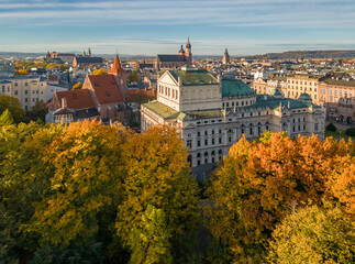 Krakow, Poland, aerial view of City Theatre (Slowacki) and Holy Cross church over colorful autumn Planty Park