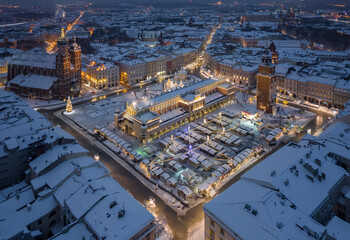 Night view of snow covered Main Square with Christmas Fairs in Krakow, Poland - 688193523