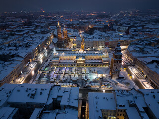Night view of snow covered Main Square with Christmas Fairs in Krakow, Poland - 688193533