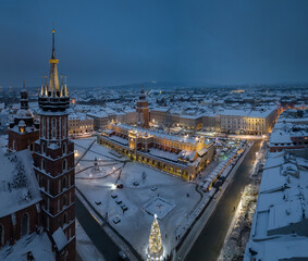 Night view of snow covered Main Square with Christmas Fairs in Krakow, Poland