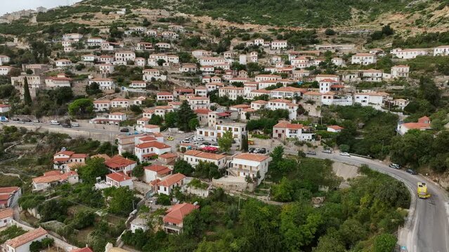 Dhermi at Sunset time. Aerial Shot of Beautiful Village Sea View, Stone Houses, beach Resort in Mountains of Albania