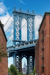 Iconic view of Manhattan Bridge, New York City, USA seen from Washington Street in Dumbo (Down Under the Manhattan Bridge Overpass), Brooklyn with Empire State Building in background